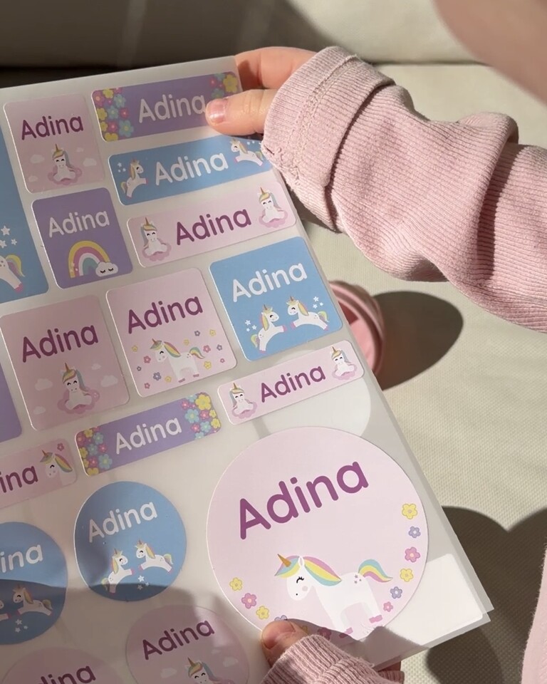 Large name labels in pink with unicorns