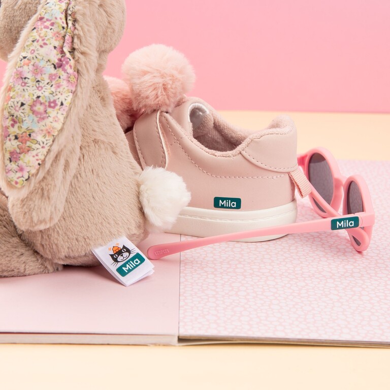 Soft toy, children's shoe and sunglasses with personalised name labels