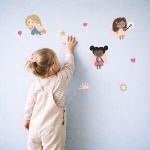 girl sticking fairy stickers on the wall