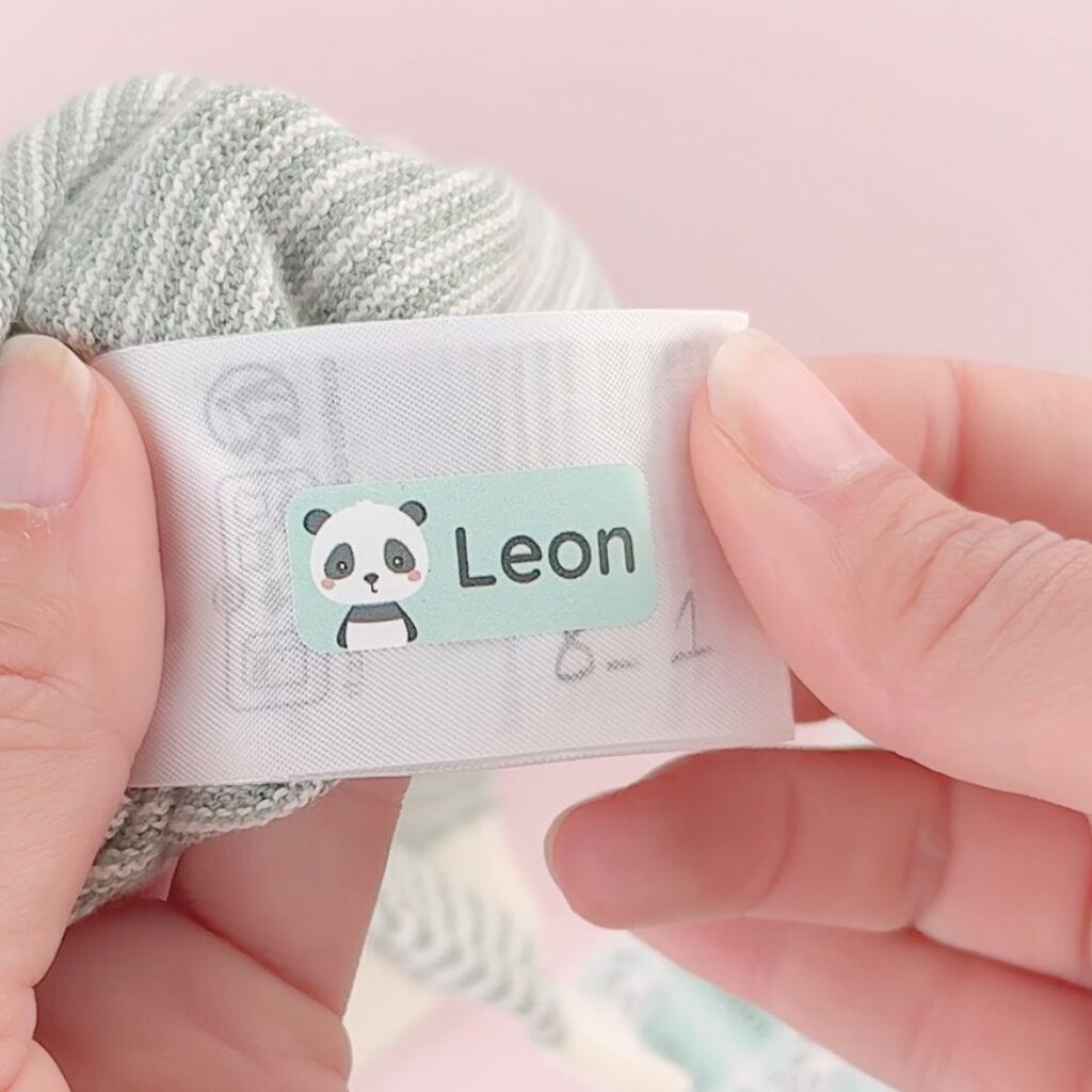 Personalised name label with a panda and the text "leon" on a care tag
