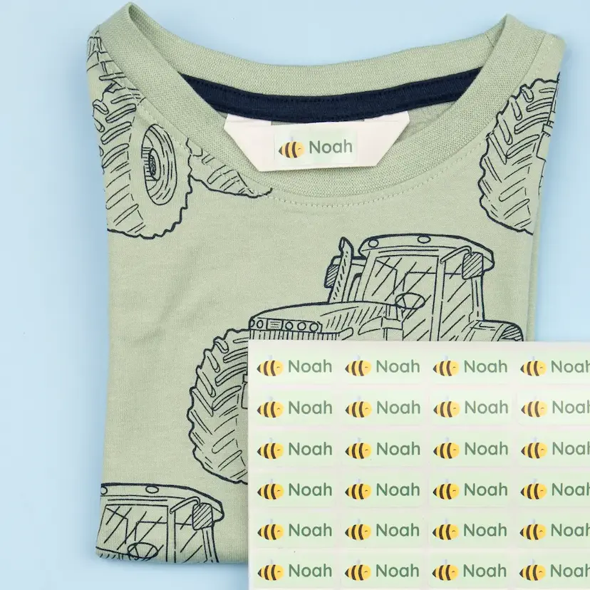 Children's t-shirt with tractor print, featuring a personalised name label with a bee motif and the name 'noah'