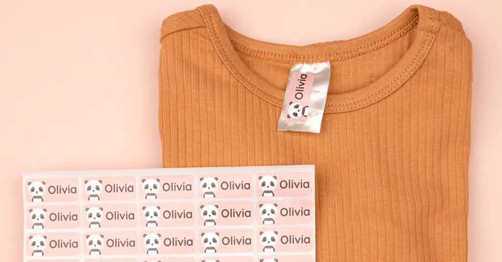 Pink name label with a panda design and the name olivia, applied to the clothing tag of a shirt