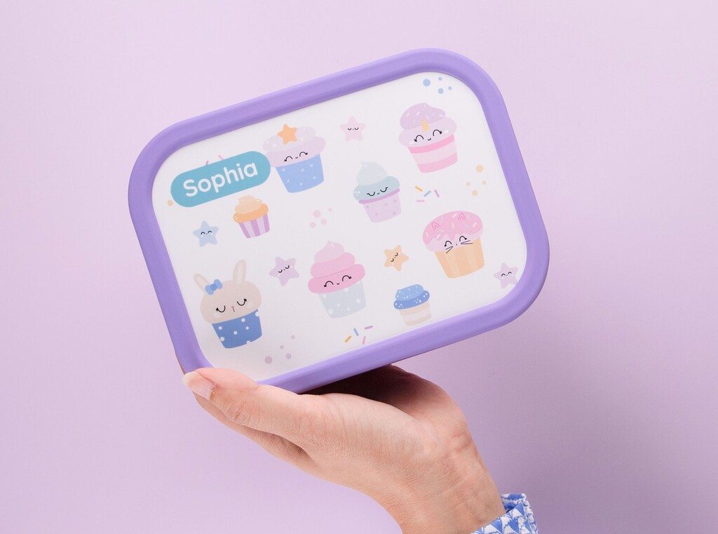 Personalised purple lunch box with cupcake designs and the name sophia printed on the lid