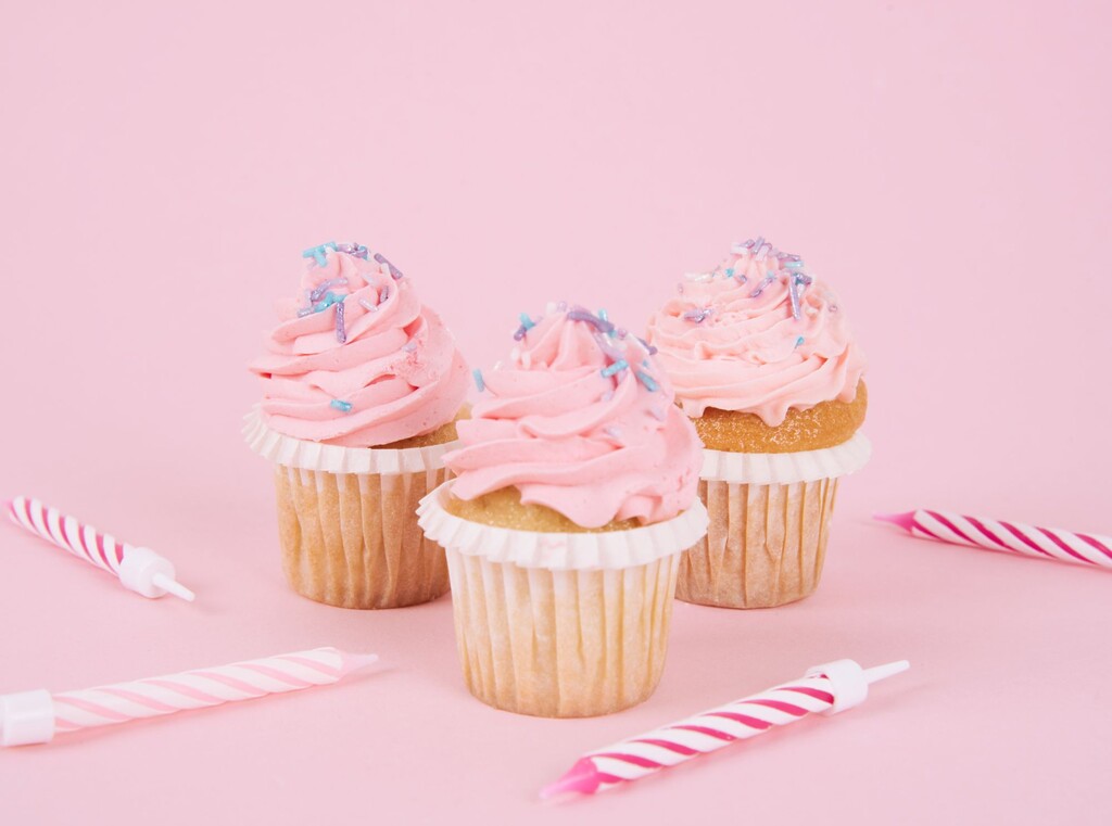 Cupcakes topped with pink icing and sprinkles, ideal for a birthday party.