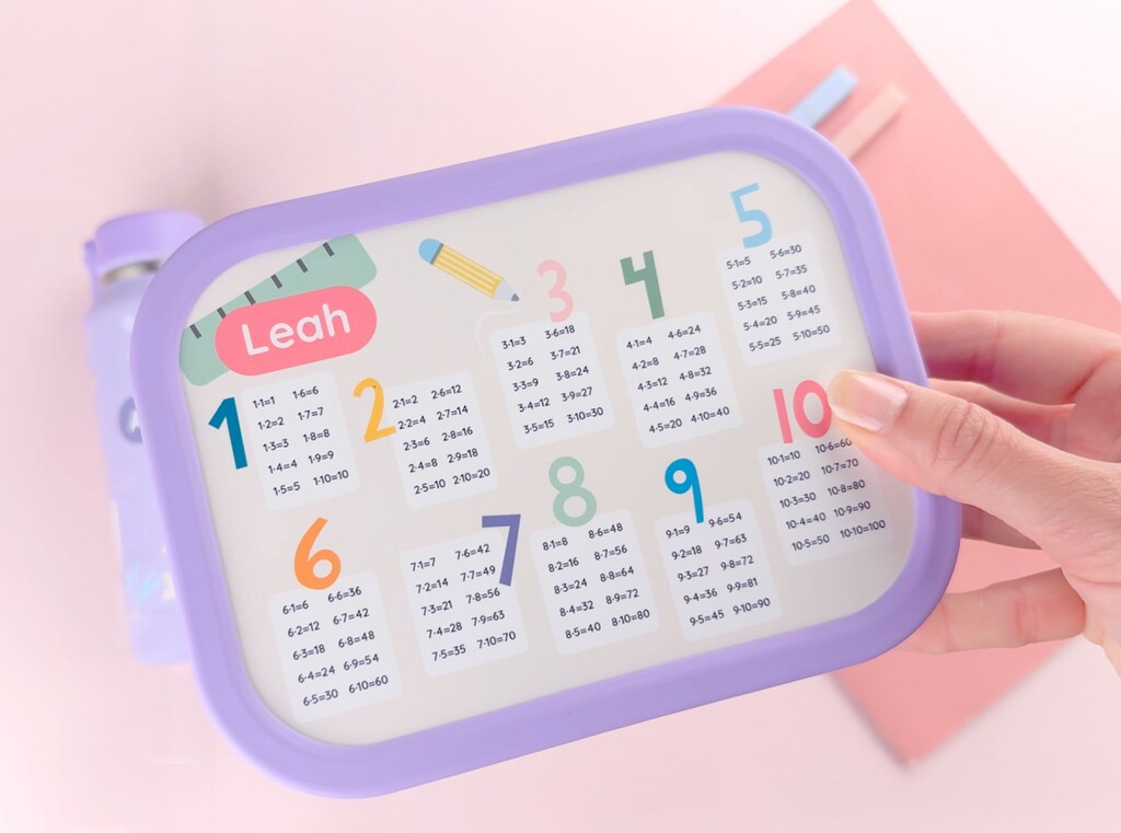 Personalised lunch box with the name leah printed on the lid, shown being held from above.