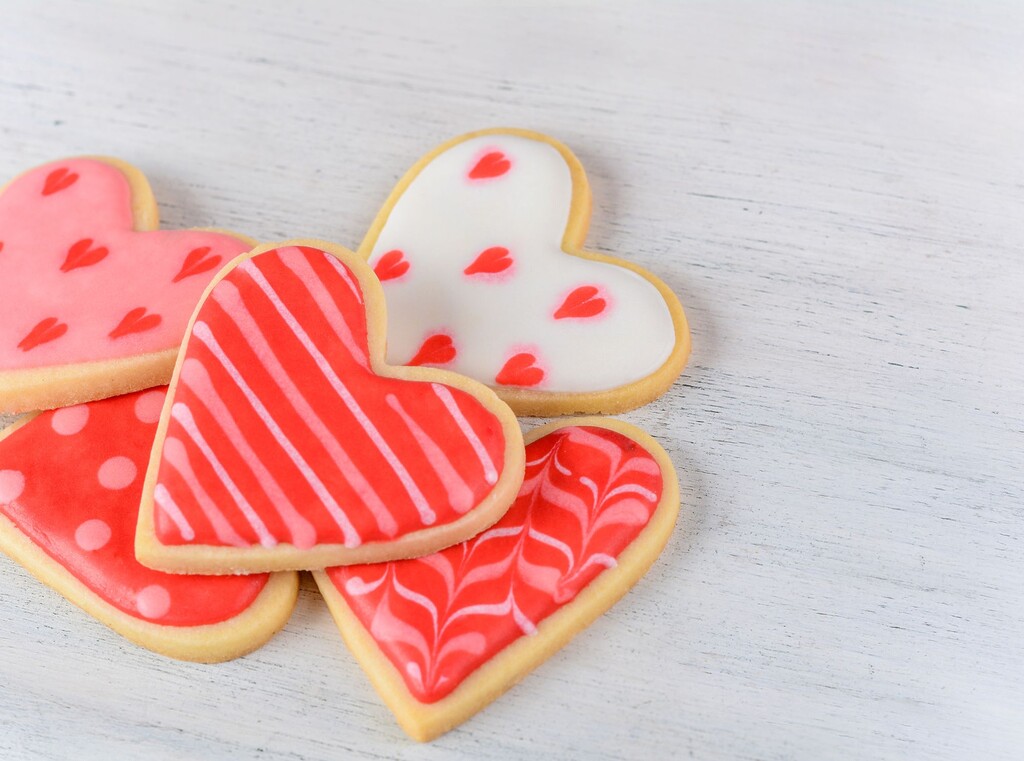 Heart-shaped sugar cookies decorated with pink and red icing.