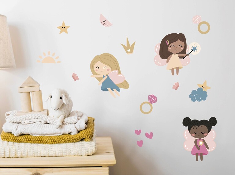Wall stickers with cute fairy designs decorating a cozy children’s bedroom