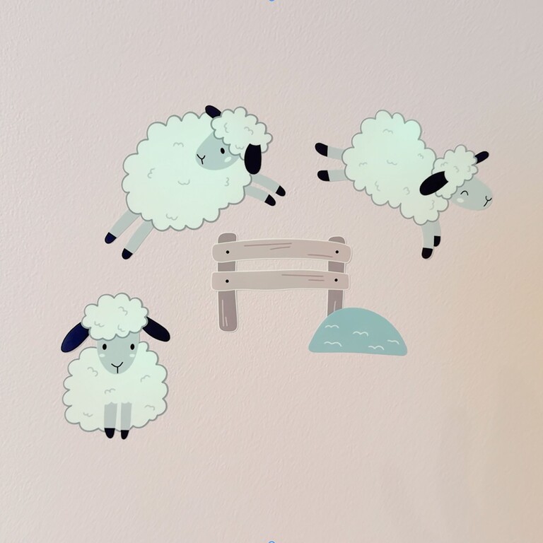 three glow-in-the-dark sheep on a kids' room wall