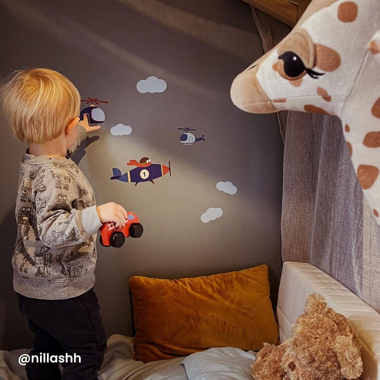 boy looking at the stickers on the wall
