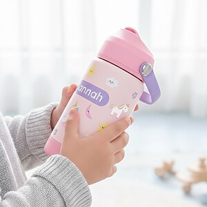 child holding a pink drinking bottle