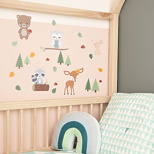 Forest animals wall stickers on a wall next to a child's bed