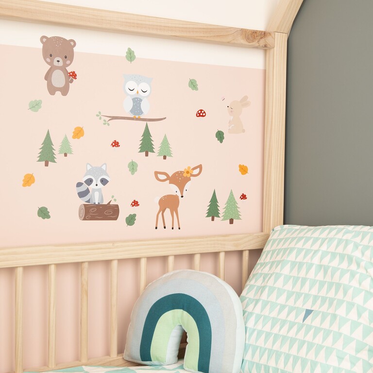 Forest animals wall stickers on a wall next to a child's bed