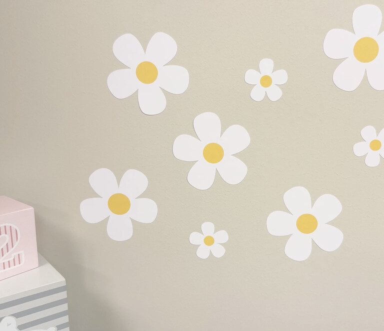 Daisy (white) wall stickers placed on a wall