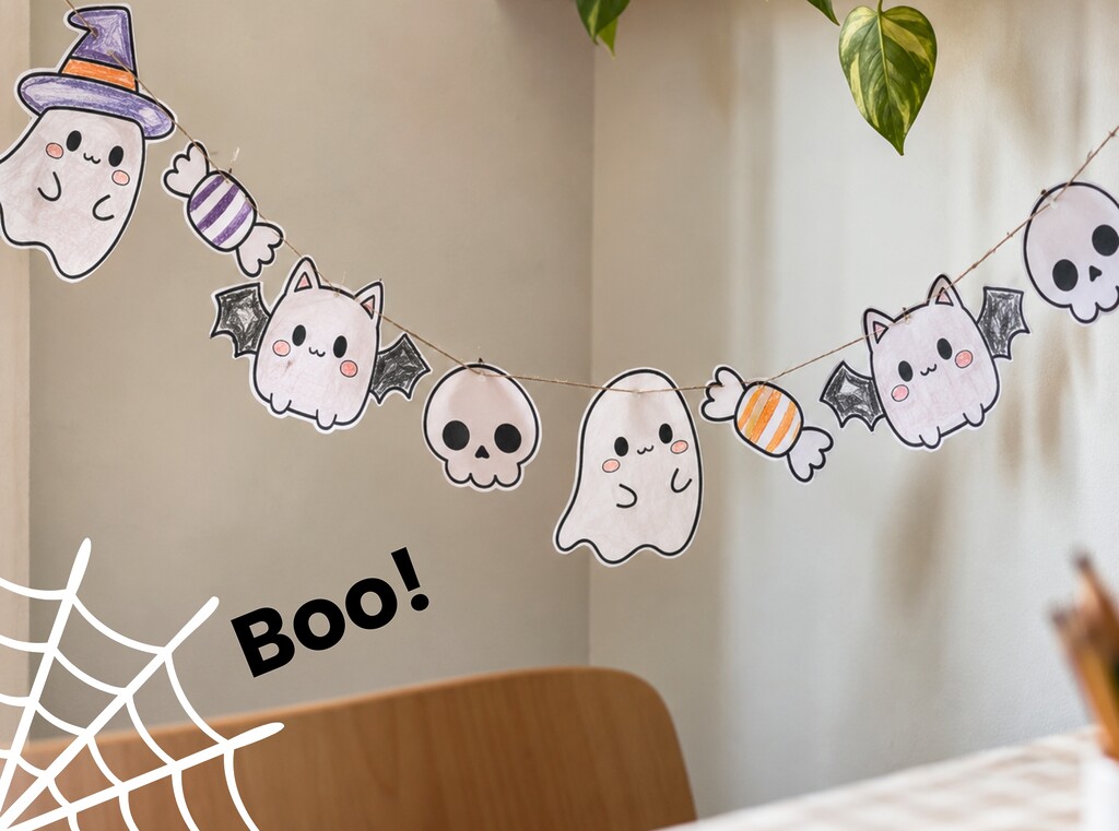 Halloween crafts for kids: free printable activity sheets 2 A finished paper halloween garland with coloured-in ghosts, bats and sweets hanging on a string